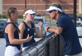 Ashlie Aldridge (left) and Bryce Kriner (center) chat with Camden head coach Daniel Breag in a 2023 match. (Andy Diffenderfer, Tribune & Georgian)