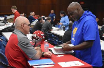 Toombs County head coach Richard Marsh (left) chats with Fort Valley State offensive line coach Kenny Ray at the Southeast Georgia Football Recruiting Fair. (Andy Diffenderfer, Tribune & Georgian)  