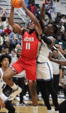 Archer’s Kahmare Holmes drives to the hoop with the Wildcats’ Ja’Marley Riddle defending. (Andy Diffenderfer, Tribune & Georgian)