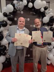 Editor and Publisher Scott J. Bryan and Assistant Editor Andy Diffenderfer show off their Georgia Press Association awards Friday night at the association’s 138 annual convention.