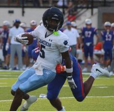 Ayden Robinson tries to avoid a tackler last Friday. (Andy Diffenderfer, Tribune & Georgian) 
