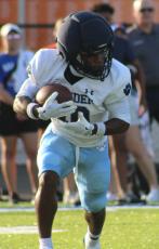 Malakhi Poole looks for yardage in the Bolles scrimmage. (Andy Diffenderfer, Tribune & Georgian) 