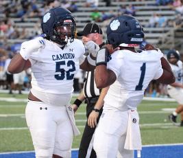 Camden County lineman Raymone Howard celebrates with quarterback Xavier Collins. (Scott J. Bryan, Tribune &. Georgian)