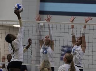In a two-set win over Colquitt, Vera Jordan and Isabella Valera attempt a block. (Andy Diffenderfer, Tribune & Georgian)