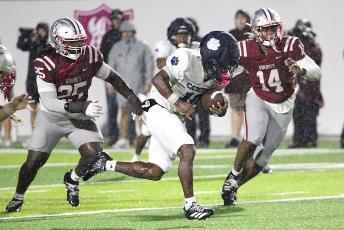 Malakhi Poole ran for 136 yards and both Wildcat touchdowns in the soggy Region 1-7A opener at Lowndes. (Scott J. Bryan, Tribune & Georgian)