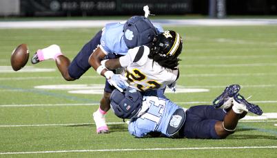 Micah Jones and Maliek Patterson meet at a Richmond Hill ballcarrier as the ball springs loose. (Scott J. Bryan, Tribune & Georgian) 