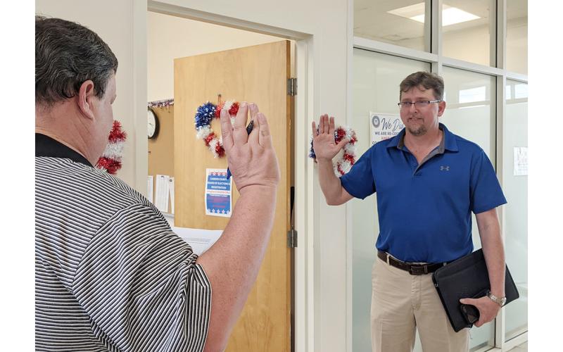 Probate judge Beau Sweatt administers the oath of office to Anthony Kicklighter at the Feb. 18 meeting of the Camden County Board of Elections and Registration.