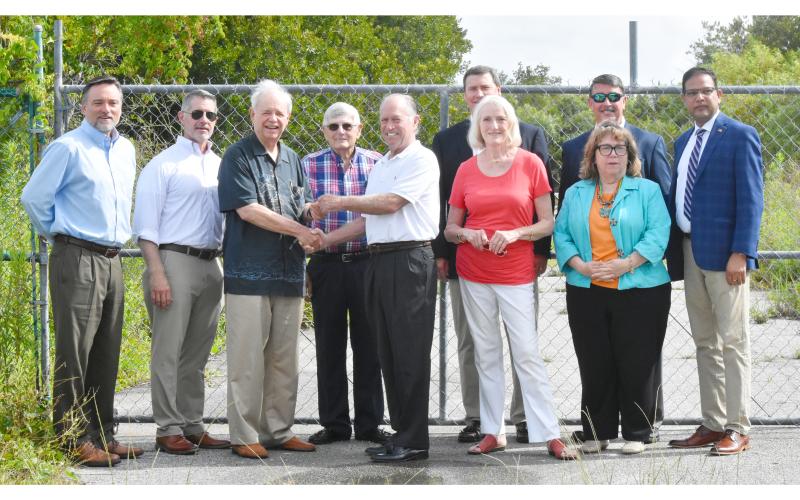 The change in ownership was celebrated on Wednesday as officials gathered for a key presentation ceremony at the gates of the Cumberland Inlet development in St. Marys. The sale of the property closed this week. Shown are (from left) Jacoby Development Inc. representative John Loudon, JDA executive director James Coughlin, master developer Jim Jacoby, JDA board member Burford Clark, bankruptcy trustee Mike Newsom, and JDA members Jeff Lockhart, Tonya Glazebrook, Jim Lomis, Rachel Baldwin and C.B. Yadav.