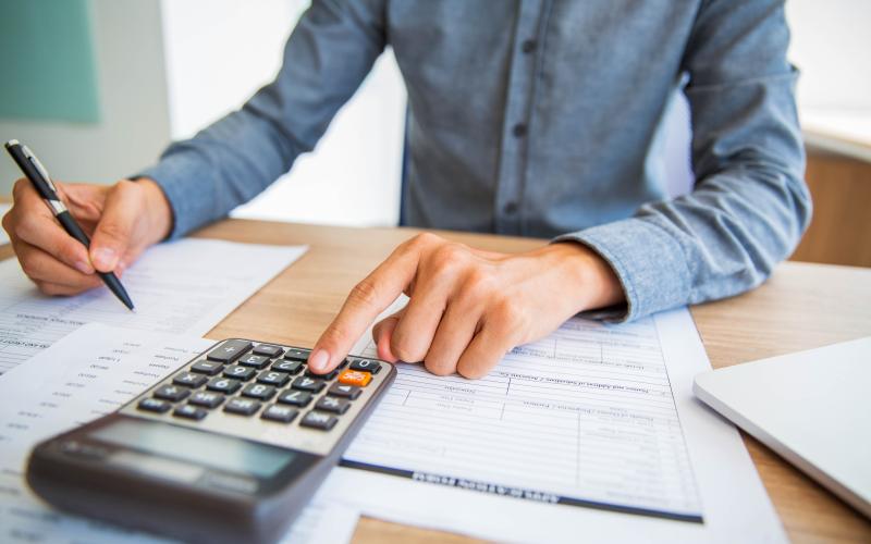 Citizen figuring taxes with a calculator