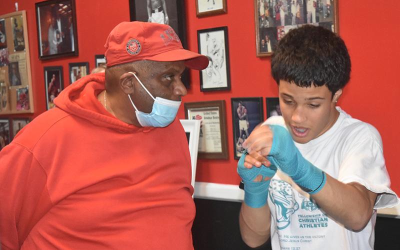 Steve Bell offers Kenny Delgado some pointers during a recent practice.