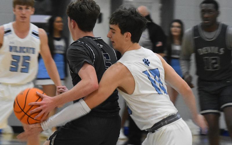 The Wildcats' Thomas Mott pokes the ball free from Tift's Will Clark. (Andy Diffenderfer/Tribune &amp; Georgian)