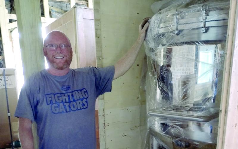 Brackish Beer Company's Jon Preble shows off a piece of equipment that will be used to brew beer in the craft beer joints new location on Osborne Street.