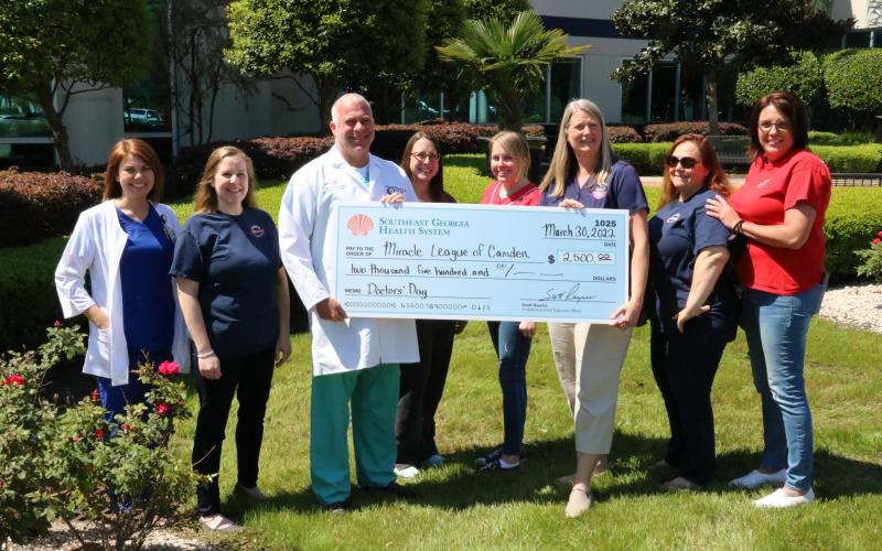 Southeast Georgia Health System’s Camden Campus Patient Care Services Jessica Wildes and Medical Staff Chief Dr. Thomas C. Whitesell Jr. participate in a check-passing with Miracle League representatives Ashley Lacoste, Erica Boyd, Cassey McCutcheon, Sarah Johnsen, Tish Fredericks and Mollie Norman.