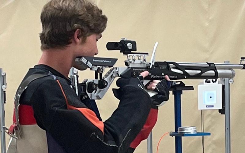 John Strassner takes aim during a riflery camp in Alabama. (Submitted photo)