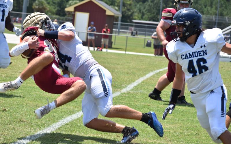 Camden County’s Ian Pederson tackles Ashley Ridge’s Quentin Birk.
