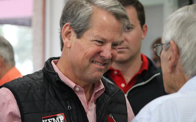 Gov. Brian Kemp speaks to a supporter prior to his breakfast rally in downtown St. Marys.