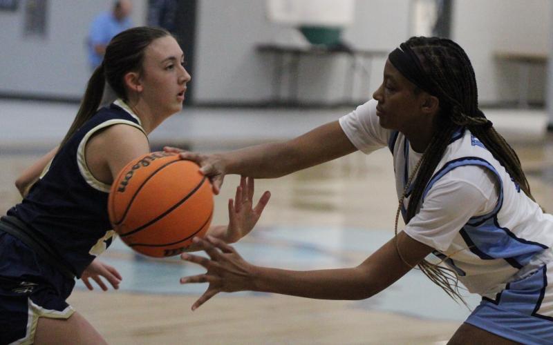The Lady Wildcats’ Dasmine Cooper tries to pass around a Brantley County defender in a preseason scrimmage. (Andy Diffenderfer, Tribune &amp; Georgian)