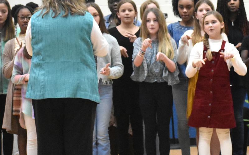 Woodbine Elementary School students perform a song Friday during the Thiokol Memorial Project’s 52nd anniversary of the deadly explosion at the Thiokol Chemical Factory.
