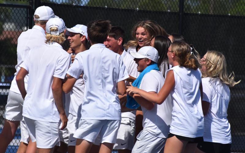 Wildcat tennis players celebrate last Friday after Tyler Klein won the deciding match at No. 3 singles and sealed the boys’ 3-2 second-round Class 7A playoff win over Parkview. (Andy Diffenderfer, Tribune &amp; Georgian)