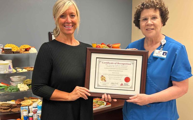 Southeast Georgia Health System’s diabetes educator, Allison Hendry, left, and Diabetes Education program coordinator Sue Ullrich show off an award the hospital recently earned.