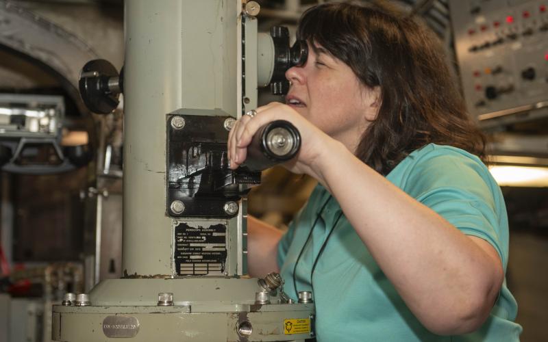 3M Senior Vice President and Global Chief Information Security Officer Carolann Shields looks through the periscope of the Ohio-class ballistic missile submarine USS Wyoming (SSBN 742) during a tour as part of the Joint Civilian Orientation Conference.