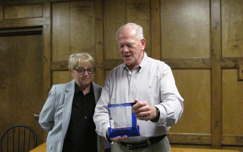 Sheriff Jim Proctor presents Capt. Harritte Sirmon with a plaque honoring her for her service in law enforcement.