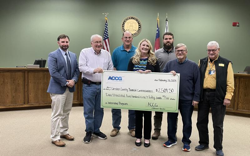 County Administrator Shawn M. Boatright, Commissioner Lannie Brant, Chairman Ben Casey, Grants Manager Julie Haigler, and Commissioners Trevor Readdick, Martin Turner and Jim Goodman show off the grant received to fund an internship program with the county government.