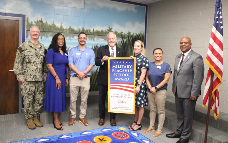 Naval Submarine Base Kings Bay Commanding Officer Capt. Chris Bohner, Camden County Schools Superintendent Tracolya Green, Camden County Board of Education Chairman Jonathon Blount, Georgia Superintendent of Schools Richard Woods, Mary Lee Clark Elementary Principal Rika Dow, Camden school board member Allison Murray and Georgia Board of Education member Nicholas Ellis celebrate Mary Lee Clark’s designation as a Military Flagship School Award winner.