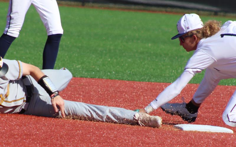 Camden County infielder Gavyn Nelson stretches for a tag attempt on Richmond Hill’s Noah Stone. (Andy Diffenderfer, Tribune &amp; Georgian)