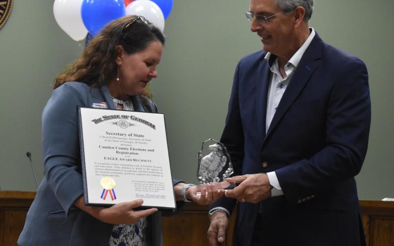 Georgia Secretary of State Brad Raffensperger, right, presents Camden County Election Supervisor Shannon Nettles with the EAGLE Award.