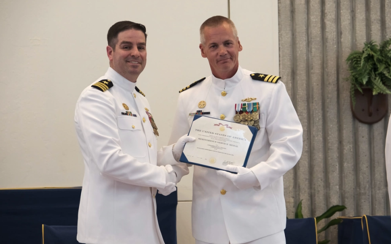 Cmdr. David Burke, deputy commodore, Submarine Squadron 20, right, awards Cmdr. Steven Dykstra the Meritorious Service Medal before relinquishing command of Ohio-class ballistic-missile submarine USS Wyoming (SSBN 742) (Blue) to Cmdr. Robert Moreno, during a change of command ceremony aboard Naval Submarine Base Kings Bay.