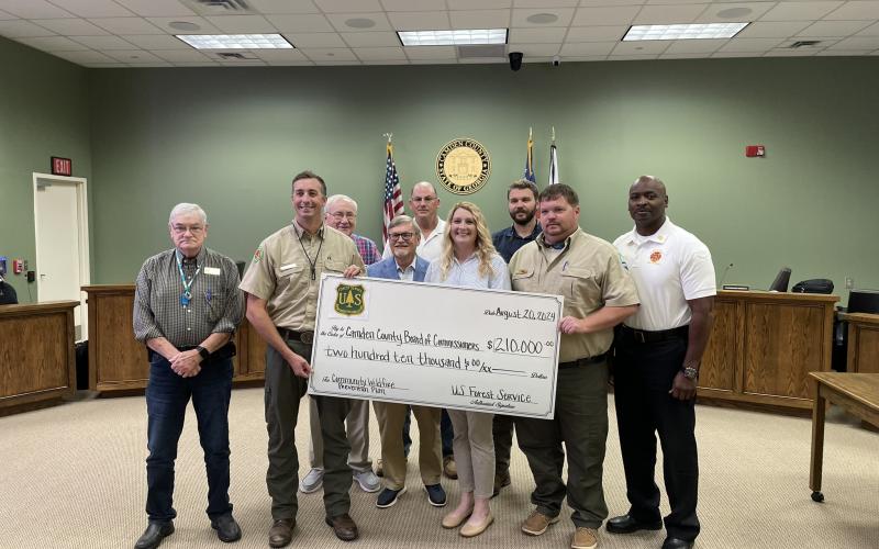 Celebrating the county’s acceptance of grant funds for a Community Wildfire Protection Plan are, from left, Camden County Commissioner Jim Goodman, Community Wildfire Defense Grant Coordinator Anthony English, Commissioners Lannie Brant and Martin Turner, Chairman Ben Casey, Grants Manager Julie Haigler, Commissioner Trevor Readdick, Georgia Forestry Ranger Frank Allen and Camden County Fire Rescue Chief Terry Smith.