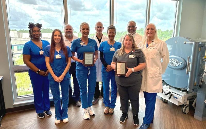 Camden Campus Wound Care Center employees Camille McGowan, Danielle Garza, Jim Hendrix, Ashley Holland, Benjamin Bograd, Soraya Williams, Damon Brantley, Jennifer Bailey and Donna Geiger share the National Award for Excellence in Wound Healing.