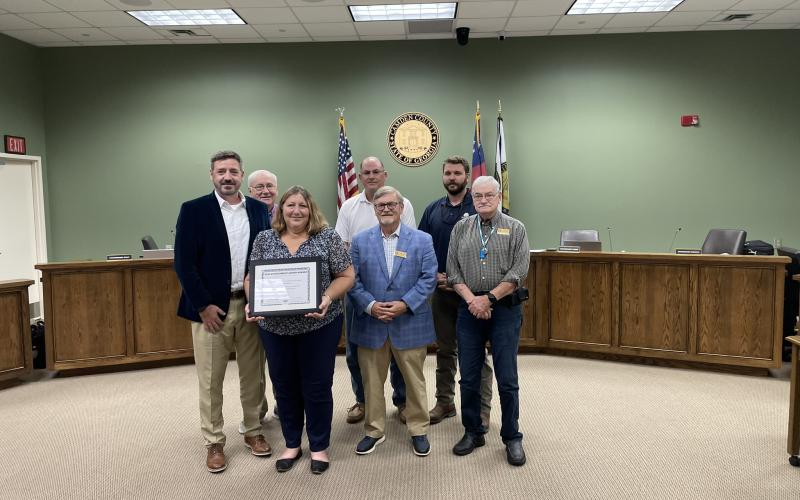 Camden County Senior Director of Human Resources and Risk Management Mike Spiers, Camden County Commissioner Lannie Brant, human resources generalist Amy Peeples, Chairman Ben Casey and Commissioners Martin Turner, Trevor Readdick and Jim Goodman celebrate a recent award.