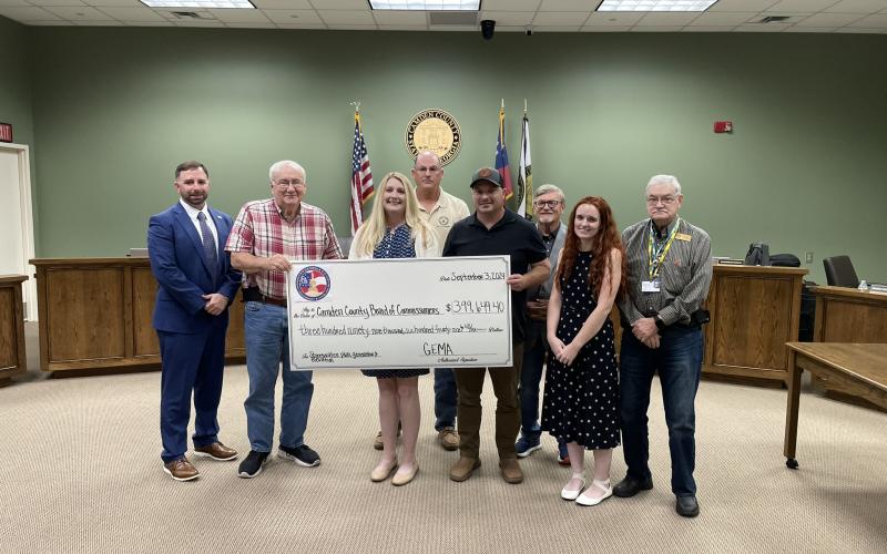 Camden County Administrator Shawn Boatright, from left, Commissioner Lannie Brant, Grants Manager Julie Haigler, Chairman Ben Casey, Maintenance Director Alex Harrellson, Commissioner Martin Turner, Floodplain and Soil and Erosion Coordinator Cassie Turpin and Commissioner Jim Goodman celebrate the county’s hazard mitigation grant.