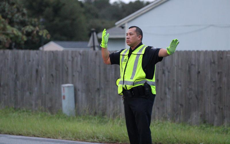 St. Marys Police Department officer Felipe Rivas directs traffic Wednesday morning in front of St. Marys Middle School. Rivas is the school resource officer and works on campus every day.