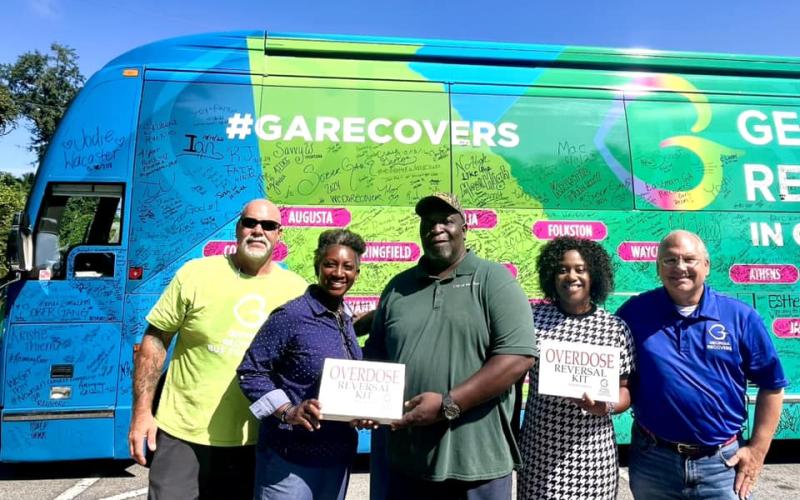 The Georgia Recovers Bus Tour recently visited Woodbine. Georgia Recovers Bus Tour manager Jon Langston, Woodbine Mayor Kizzi Knight, Jimmie Cohen, City Administrator Samantha Jackson and Georgia Council for Recovery policy advisor Jeff Breedlove show off the two Narcan kits donated to the city of Woodbine.