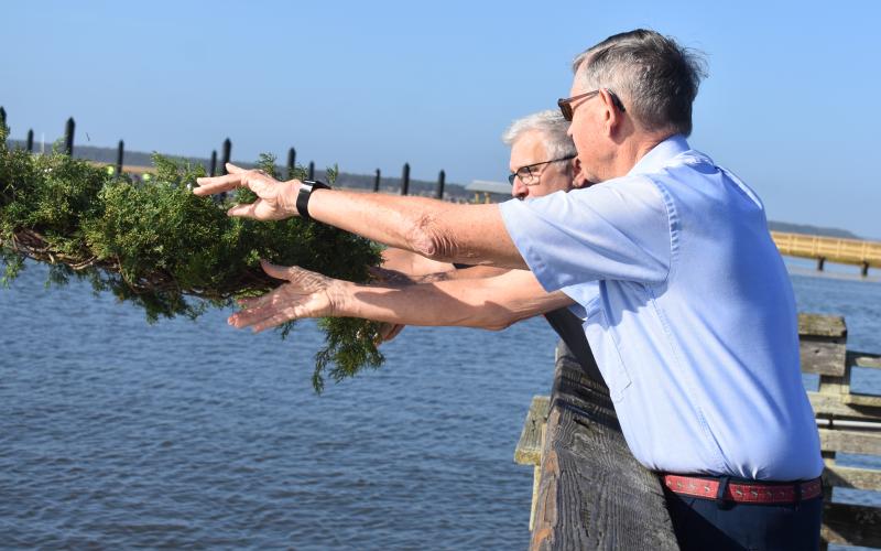 St. Marys Submarine Museum Executive Director Keith Post, rear, and retired Air Force Maj. Gen. Bob Dickman lay a wreath in the St. Marys River.