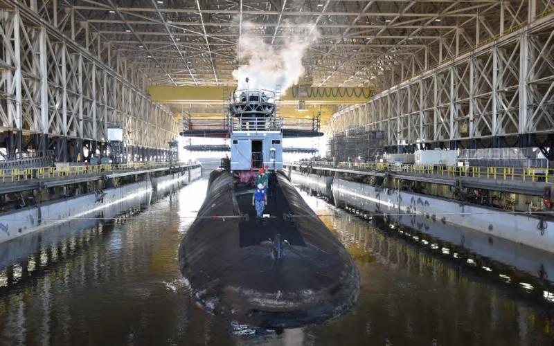 An Ohio-class nuclear-powered ballistic missile submarine (SSBN) enters the Trident Refit Facility Dry Dock for a repair and maintenance period. The dry dock is one of the largest covered dry docks in the world.