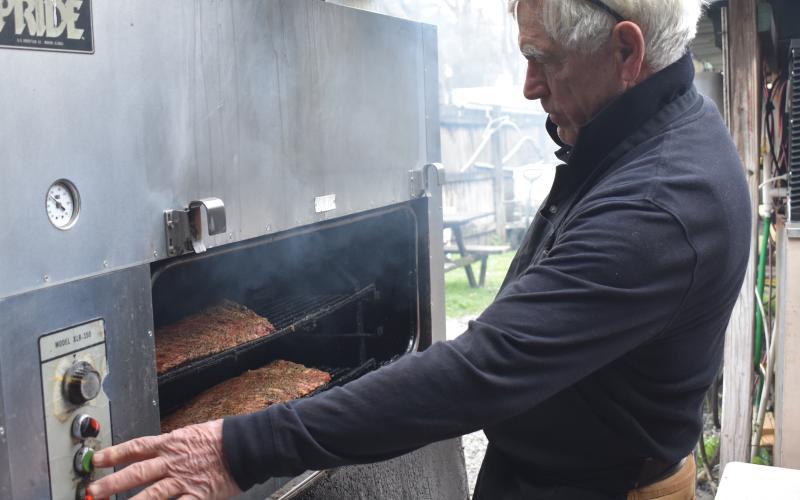 Captain Stan’s Smokehouse’s owner Stan Mieloch smokes some meat last week before the dinner rush.
