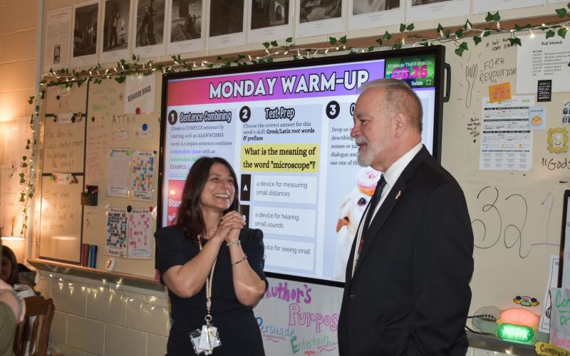 Camden Middle School sixth-grade English/language arts teacher Jenny Ritchotte, left, learns from Georgia Superintendent of Education Richard Woods that she’s been named a top-10 finalist for Georgia Teacher of the Year.
