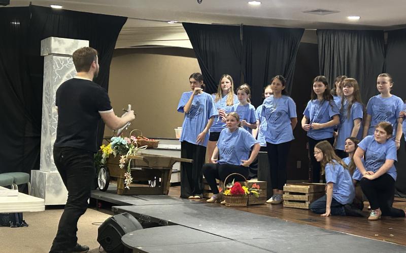 Saltwater Performing Arts’ “My Fair Lady” ensemble members rehearse a number with visiting guest director and Broadway actor Colin Anderson.