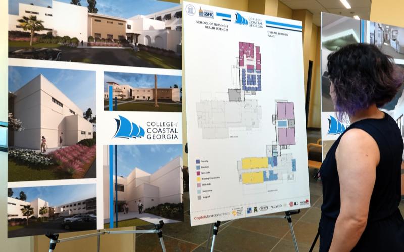 Interim Assistant Vice President for Academic Student Engagement and Professor of Chemistry Colleen Knight looks at the rendering and floor plans of the expansion of Miriam and Hugh Nunnally Hall.