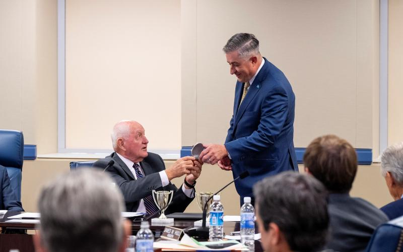 University System of Georgia Chancellor Sonny Perdue, left, presents College of Coastal Georgia President Johnny L. Evans Jr. with the Chancellor’s Cup at the USG Board of Regents meeting in August.