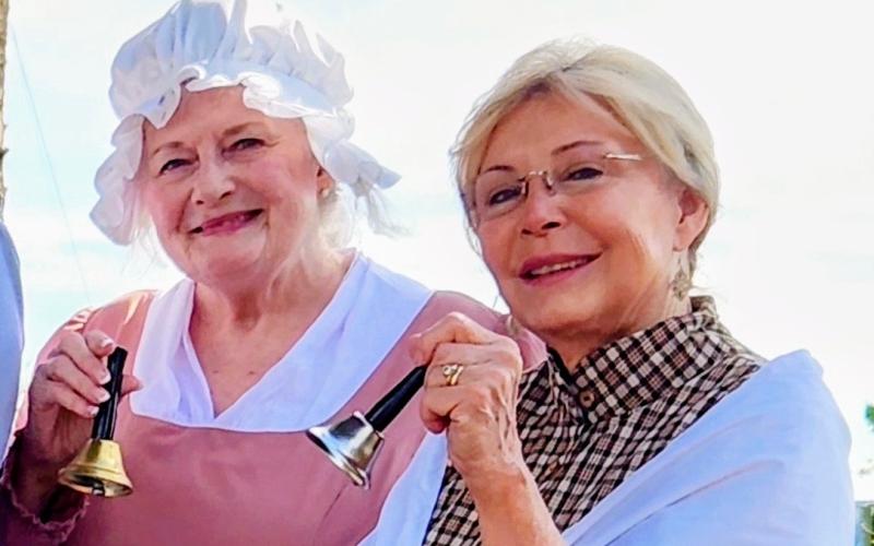 The Earl of Camden Chapter of the National Society of the Daughters of the American Revolution’s Pamela Kimes, left, and Maggie Williams, ring bells at a national bell ringing ceremony.