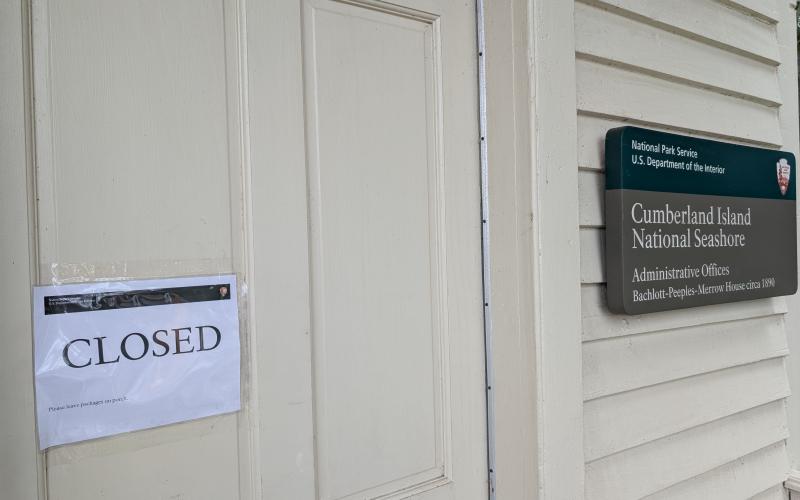 A sign outside the National Park Service’s St. Marys office has a closed sign. Because of the federal government shutdown, Cumberland Island is also not open.