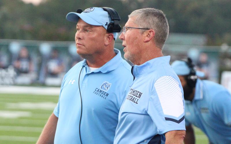 Camden County High School’s new head football coach, Jon Lindsey, left, discusses an on-field adjustment with former football coach Jeff Herron during a 2023 football game. Lindsey was named the new football coach of the program Friday.