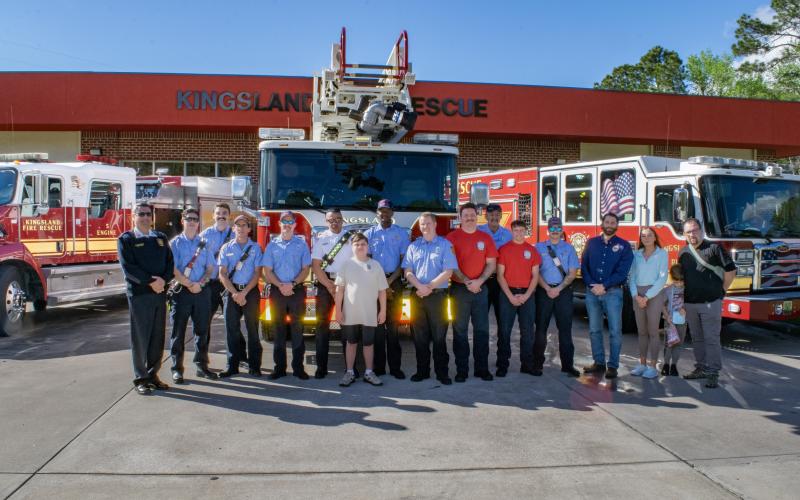 Kingsland Deputy Fire Chief Bill Carreira, left, Alex Gonzalez, seventh from left, Kingsland Mayor Grayson Day Jr., fourth from right, and others are surrounded by the rescue team from Kingsland Fire Rescue Station 4.
