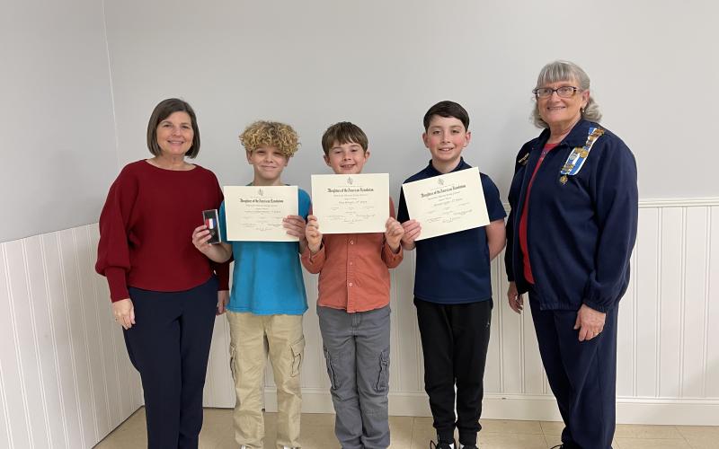Earl of Camden Daughters of the American Revolution Essay Coordinator Ardith Sweatt stands with, from left, first-place winner Hudson DeBenedetto, second-place winner Riley Brewer, third-place winner Sawyer Coley and Chapter Regent Karen Kerner.