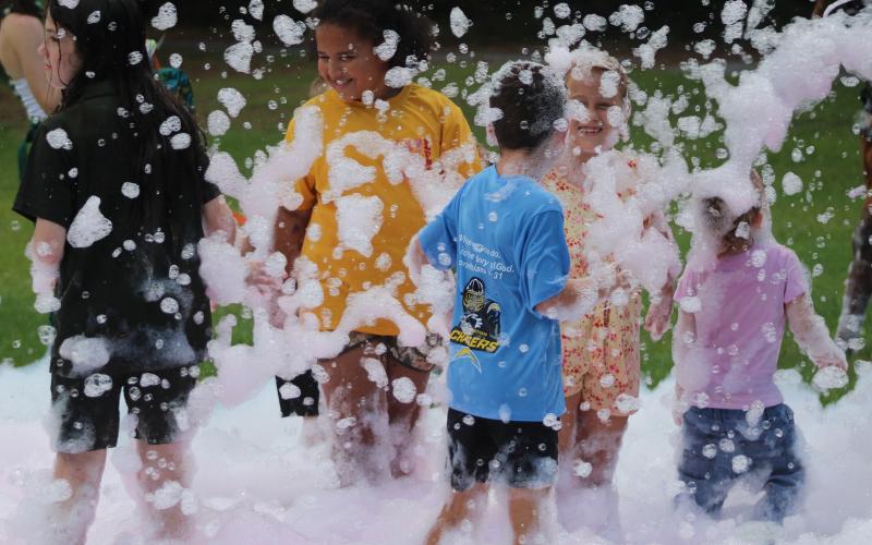 Children play in the foam machine Tuesday during Camden Family Connection’s annual Party in the Park at Crooked River State Park.